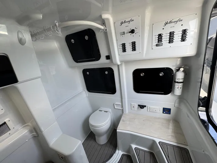  Yacht Photos Pics 2023 Yellowfin 42 boat interior with toilet, control panels, and fire extinguisher.