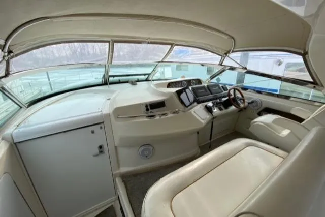 Fresh Water 450 Sundancer Yacht Photos Pics 1997 Sea Ray 450 Sundancer helm with beige interior and modern navigation equipment.