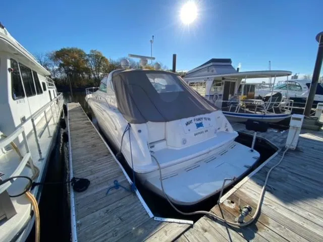 Fresh Water 450 Sundancer Yacht Photos Pics 1997 Sea Ray 450 Sundancer docked at marina under clear blue sky.