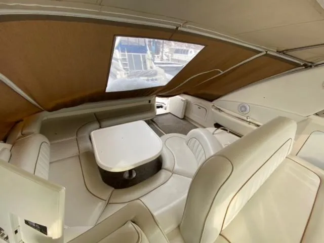 Fresh Water 450 Sundancer Yacht Photos Pics Interior of 1997 Sea Ray 450 Sundancer yacht with white leather seating and table.