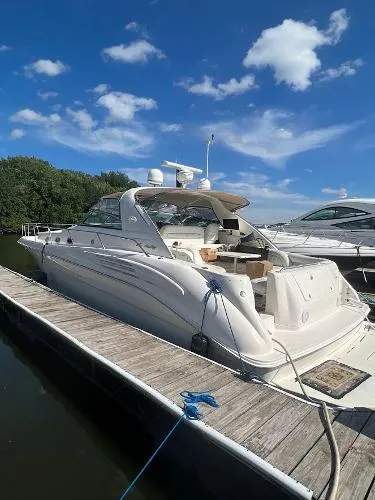 Fresh Water 450 Sundancer Yacht Photos Pics 1997 Sea Ray 450 Sundancer yacht docked under a clear blue sky.