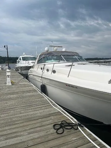 Fresh Water 450 Sundancer Yacht Photos Pics 1997 Sea Ray 450 Sundancer yacht docked at a marina under cloudy skies.