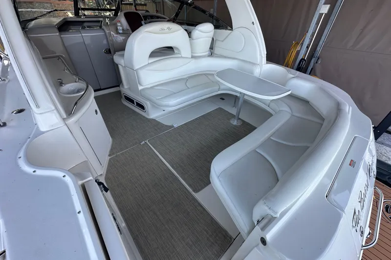  Yacht Photos Pics 2004 Sea Ray 380 Sundancer interior with white seating and table in cockpit area.