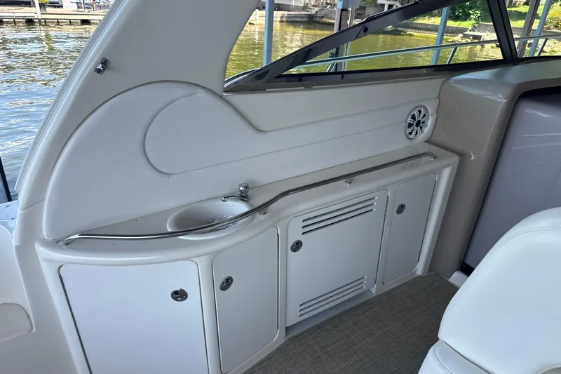  Yacht Photos Pics 2004 Sea Ray 380 Sundancer interior with sink and storage, docked by the water.