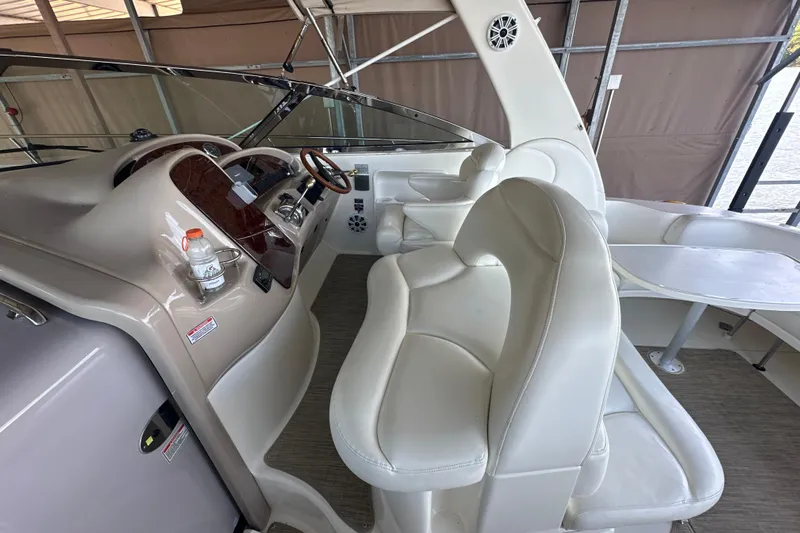  Yacht Photos Pics 2004 Sea Ray 380 Sundancer cockpit with white leather seats and modern dashboard.