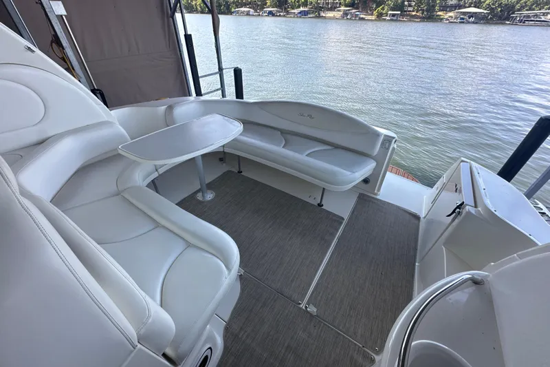  Yacht Photos Pics 2004 Sea Ray 380 Sundancer boat interior with white seating and table, overlooking water.