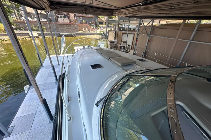  Yacht Photos Pics 2004 Sea Ray 380 Sundancer docked under a covered marina, showcasing sleek design and spacious deck.