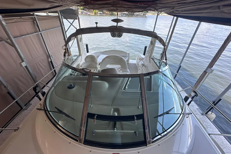  Yacht Photos Pics 2004 Sea Ray 380 Sundancer docked under canopy, showcasing sleek design and spacious cockpit.