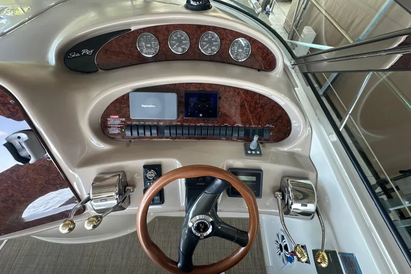  Yacht Photos Pics 2004 Sea Ray 380 Sundancer helm with wood accents and modern navigation controls.