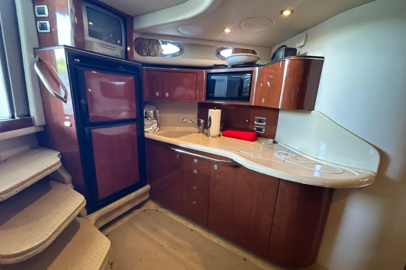  Yacht Photos Pics Luxurious 2004 Sea Ray 380 Sundancer yacht kitchen with wood cabinetry and modern appliances.