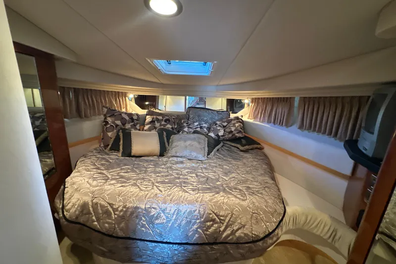  Yacht Photos Pics Luxurious cabin interior of 2004 Sea Ray 380 Sundancer with plush bedding and ambient lighting.