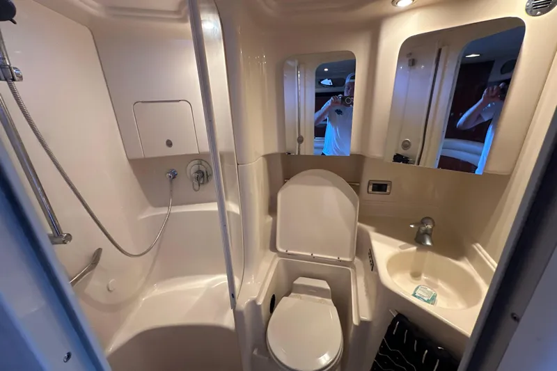 Yacht Photos Pics Bathroom interior of 2004 Sea Ray 380 Sundancer yacht, featuring shower, toilet, and sink.