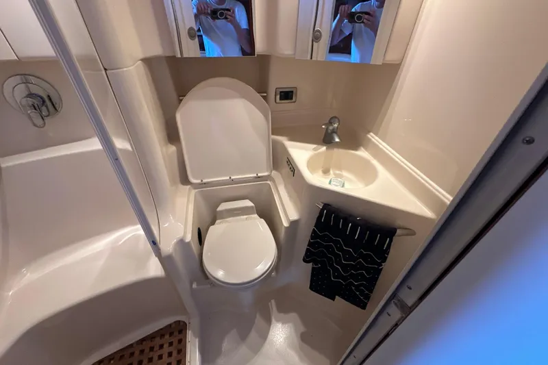  Yacht Photos Pics 2004 Sea Ray 380 Sundancer bathroom with toilet, sink, and shower area.