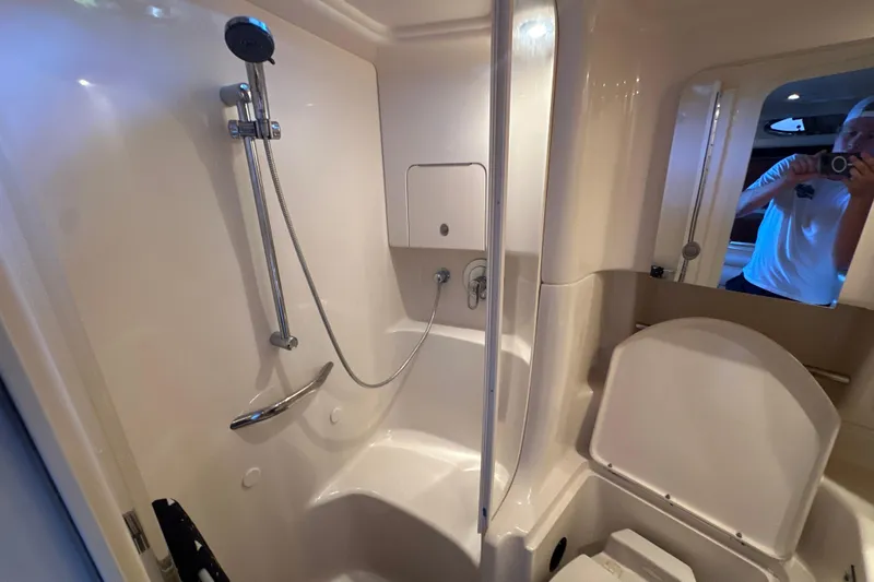  Yacht Photos Pics Bathroom interior of 2004 Sea Ray 380 Sundancer yacht, featuring shower and toilet.