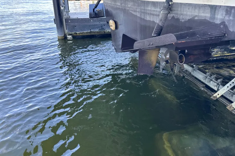  Yacht Photos Pics 2004 Sea Ray 380 Sundancer stern and propeller near dock, partially submerged in water.