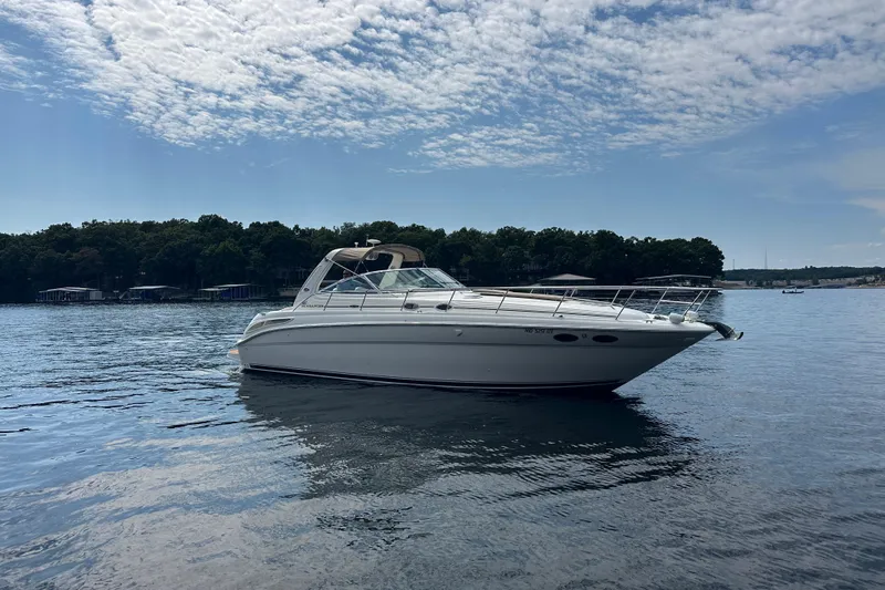  Yacht Photos Pics 2004 Sea Ray 380 Sundancer yacht on calm water under a partly cloudy sky.