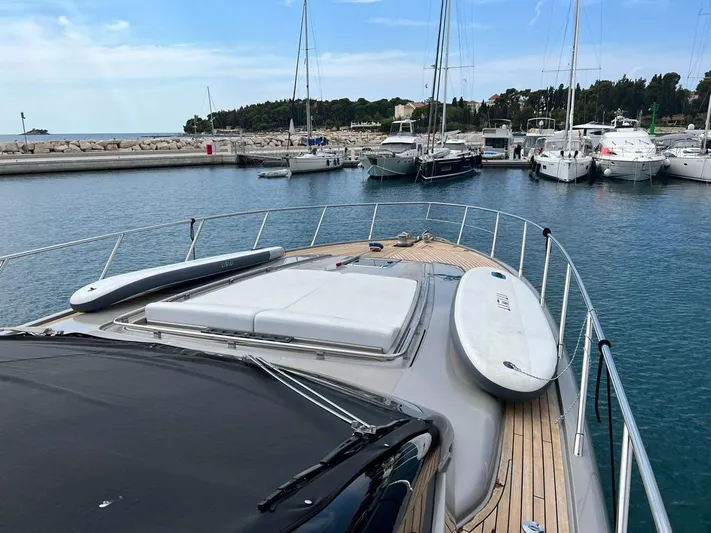  Yacht Photos Pics Luxurious 2010 Riva Vertigo 63 yacht docked in a serene marina setting.