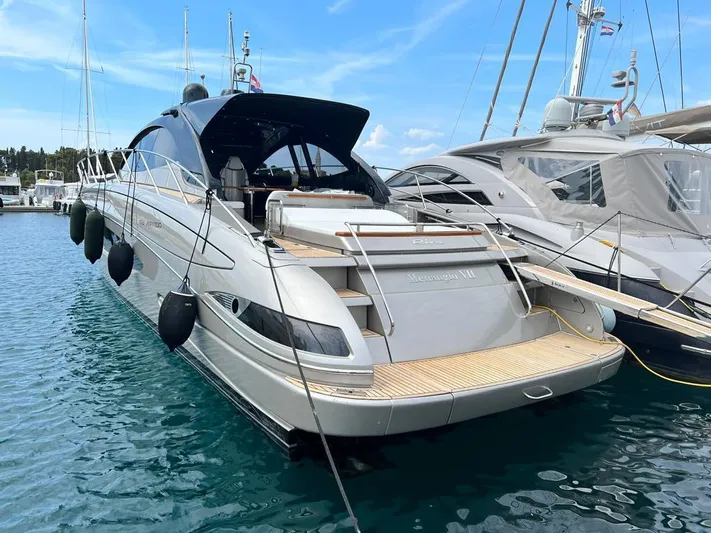  Yacht Photos Pics Luxury Riva Vertigo 63 yacht, 2010 model, docked in a marina with clear blue water.