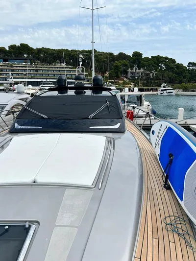  Yacht Photos Pics 2010 Riva Vertigo 63 yacht docked, showcasing sleek design and wooden deck.