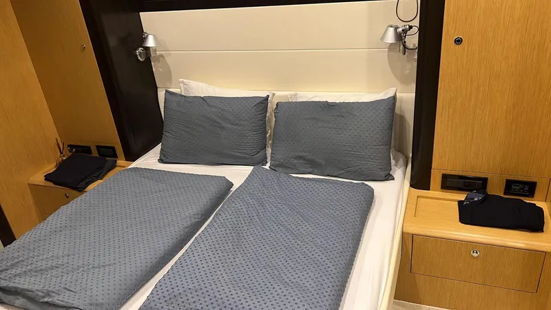  Yacht Photos Pics Luxurious bedroom interior of 2010 Riva Vertigo 63 yacht with modern bedding and wooden accents.