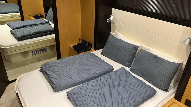  Yacht Photos Pics Luxurious bedroom interior of 2010 Riva Vertigo 63 yacht with blue bedding.