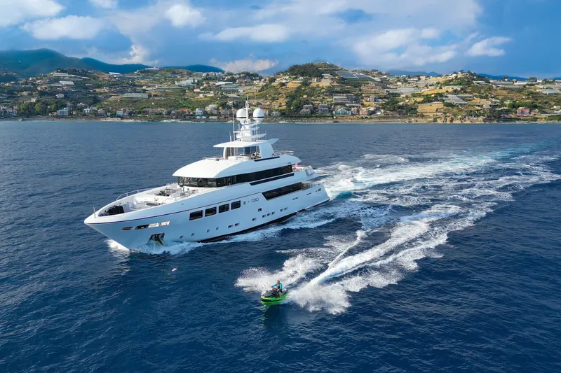 Okko Yacht Photos Pics Luxurious 2013 Mondomarine 41M yacht cruising with jet ski in scenic coastal waters.