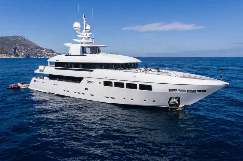 Okko Yacht Photos Pics Luxurious 2013 Mondomarine 41M yacht cruising on open sea with scenic coastal backdrop.