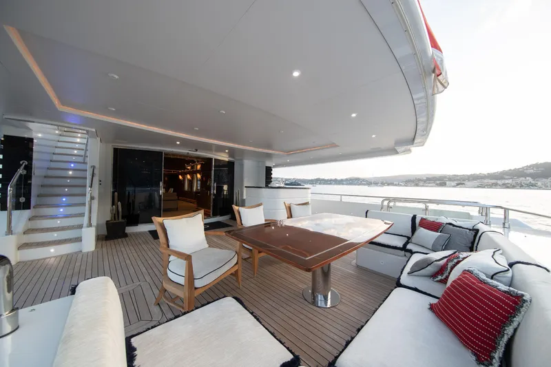 Okko Yacht Photos Pics Luxurious Mondomarine 41M yacht deck with elegant seating, wooden table, and scenic ocean view.