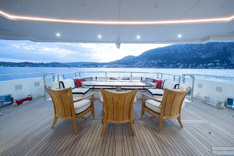 Okko Yacht Photos Pics Luxurious Mondomarine 41M yacht deck with elegant seating, overlooking serene waters and scenic mountains, 2013 model.