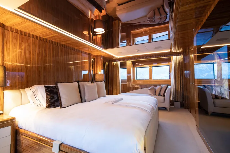 Okko Yacht Photos Pics Luxurious Mondomarine 41M yacht bedroom, 2013 model, featuring elegant wood paneling and plush bedding.