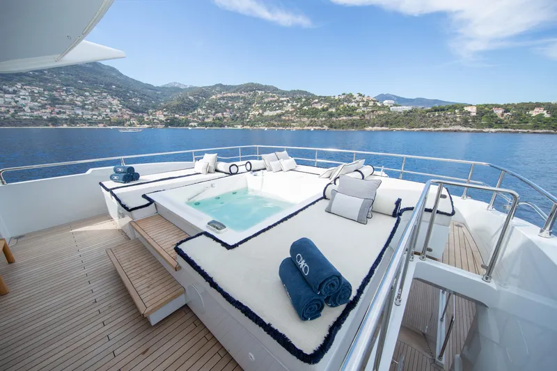 Okko Yacht Photos Pics Luxurious Mondomarine 41M yacht deck with jacuzzi, overlooking serene coastal landscape, 2013 model.