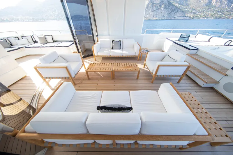 Okko Yacht Photos Pics Luxurious Mondomarine 41M yacht deck with elegant white seating, wooden flooring, and scenic ocean view.