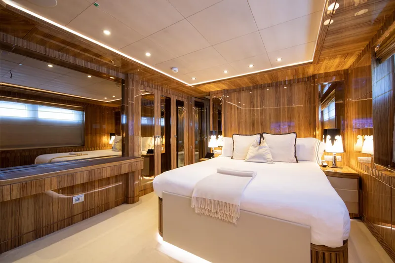 Okko Yacht Photos Pics Luxurious bedroom interior on 2013 Mondomarine 41M yacht, featuring elegant wood paneling and ambient lighting.