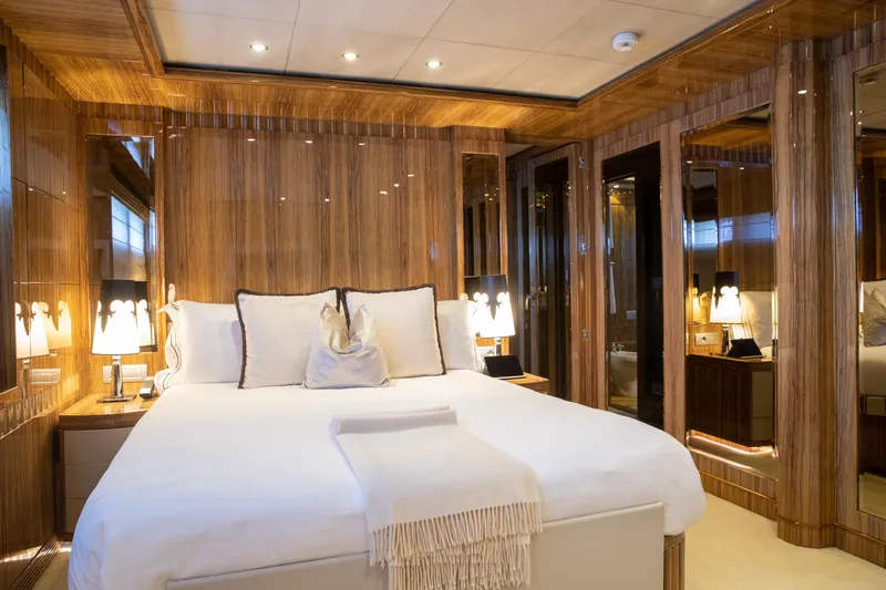 Okko Yacht Photos Pics Luxurious Mondomarine 41M 2013 yacht bedroom with elegant wood paneling and plush bedding.