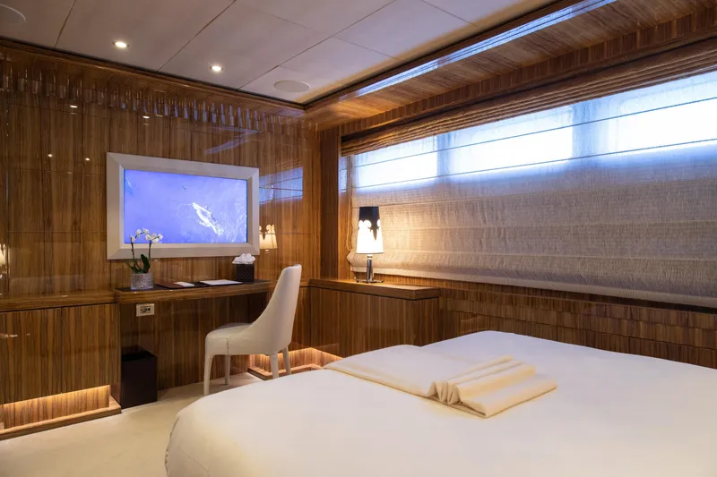 Okko Yacht Photos Pics Luxurious Mondomarine 41M 2013 yacht bedroom with elegant wood paneling and modern decor.