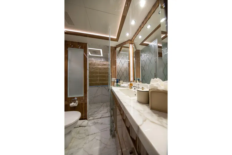 Okko Yacht Photos Pics Luxurious bathroom on 2013 Mondomarine 41M yacht with marble finishes and modern fixtures.