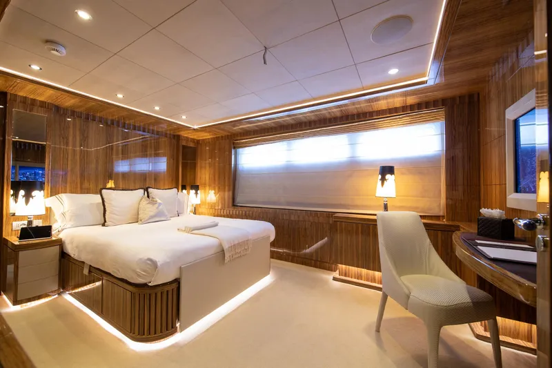 Okko Yacht Photos Pics Luxurious Mondomarine 41M 2013 yacht bedroom with elegant wood paneling and ambient lighting.