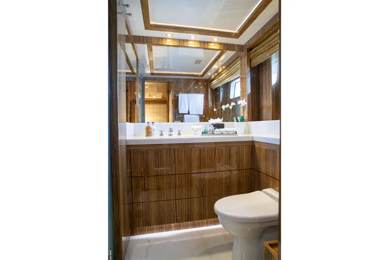 Okko Yacht Photos Pics Luxurious bathroom in 2013 Mondomarine 41M yacht with wood accents and modern fixtures.
