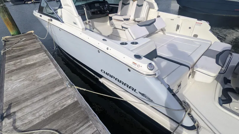  Yacht Photos Pics 2020 Chaparral 280 OSX boat docked, showcasing sleek design and spacious seating.