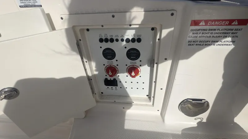  Yacht Photos Pics Control panel on a 2020 Chaparral 280 OSX boat, featuring switches and warning labels.