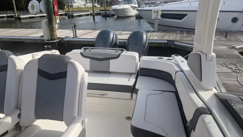  Yacht Photos Pics 2020 Chaparral 280 OSX boat interior with seating, docked at marina.