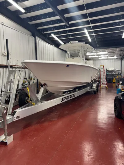  Yacht Photos Pics 2022 Contender 32 ST boat on trailer in a spacious indoor facility.