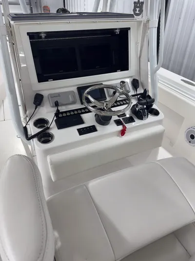  Yacht Photos Pics 2022 Contender 32 ST boat console with steering wheel and navigation controls.