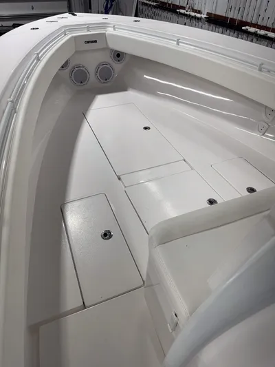  Yacht Photos Pics 2022 Contender 32 ST boat interior with white seating and storage compartments.