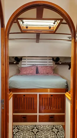 Minkie B Yacht Photos Pics Cozy cabin interior of 1997 Lyman-Morse Custom Flybridge with wood accents and skylight.