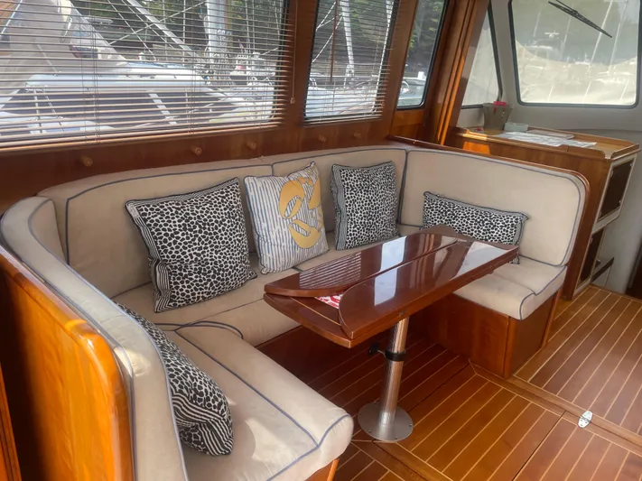 Minkie B Yacht Photos Pics 1997 Lyman-Morse Custom Flybridge interior with elegant seating and wooden table.