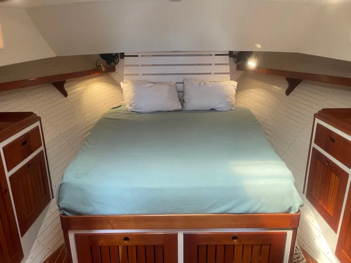 Minkie B Yacht Photos Pics Cozy cabin interior of 1997 Lyman-Morse Custom Flybridge with wooden accents and a comfortable bed.