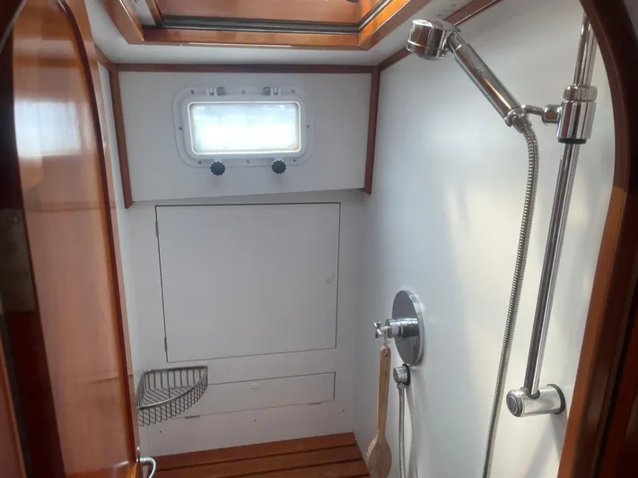 Minkie B Yacht Photos Pics Shower area in 1997 Lyman-Morse Custom Flybridge yacht with wooden accents and window.