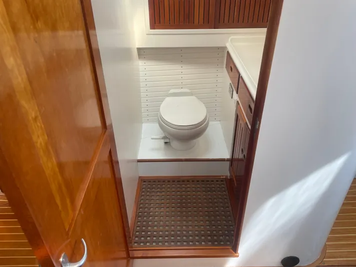 Minkie B Yacht Photos Pics 1997 Lyman-Morse Custom Flybridge yacht bathroom with wooden accents and modern fixtures.