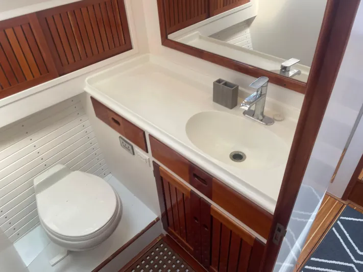 Minkie B Yacht Photos Pics Bathroom interior of 1997 Lyman-Morse Custom Flybridge yacht with sink and toilet.